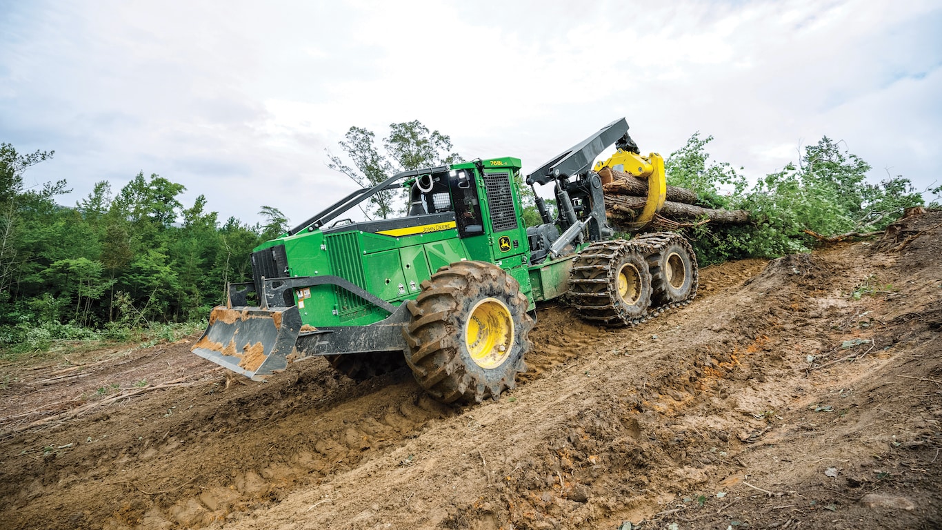  2024 John deere 768L 2 Bogie Skidder dragging full sized trees down a muddy hill