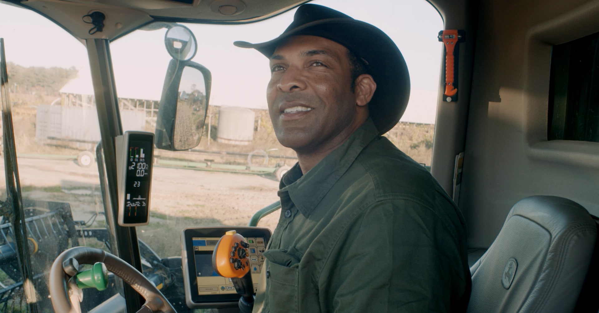 A picture of P.J. Haynie in the cab of a tractor.