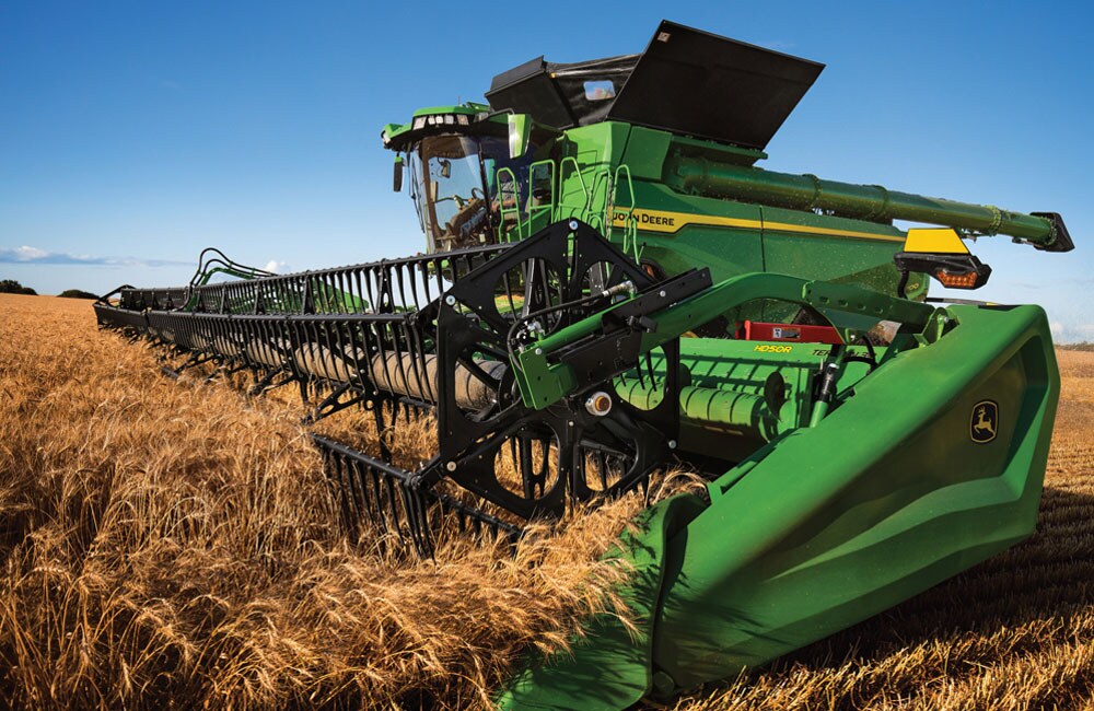 John Deere X9 1100 combine harvesting wheat