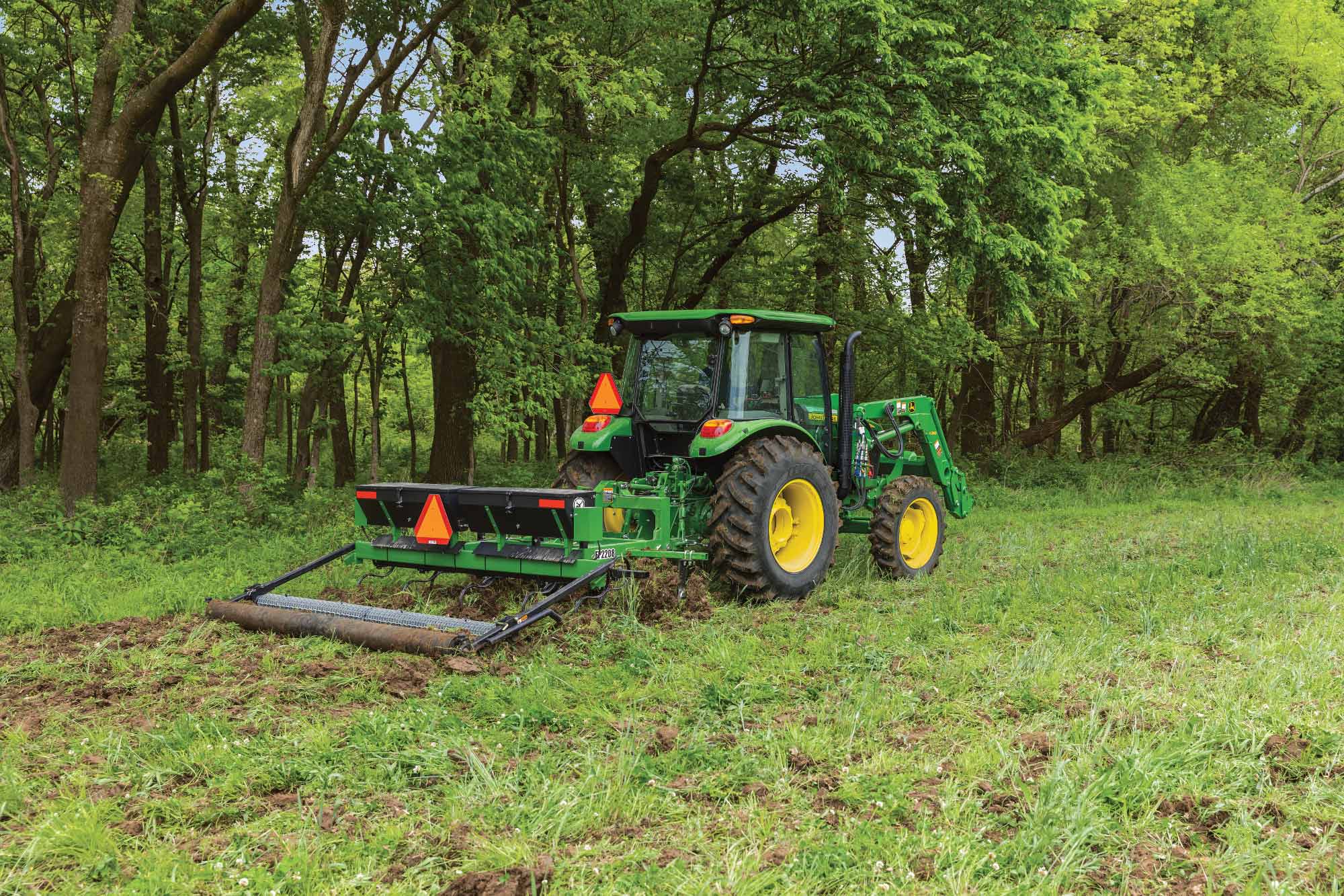 A 5075E Tractor pulling a Frontier Food Plot Planter improving wildlife habitats