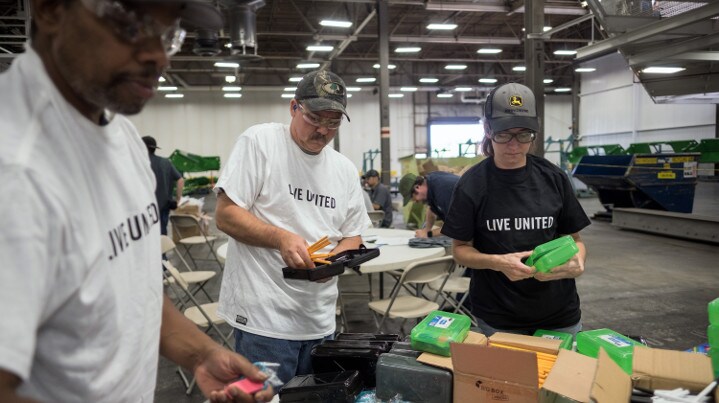 John Deere employees assembling snack packs.