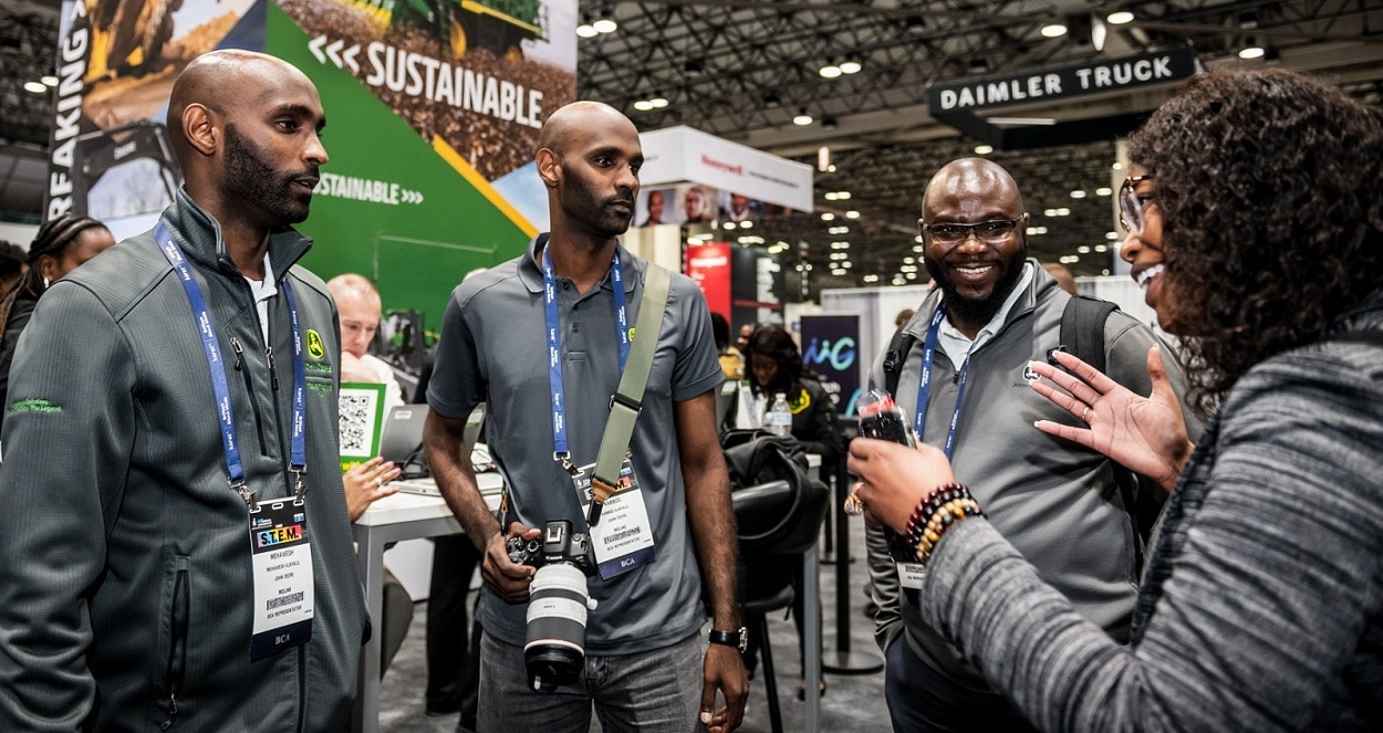 Mehawesh Alkhalil and Kabbod Alkhalil join Setordji Abotsi and Ceená Beall at the National Society of Black Engineers John Deere booth.