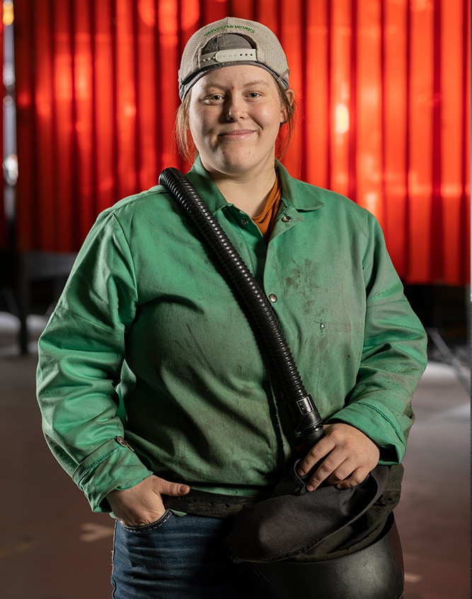 Abigail Parsons stands with her welding helmet.