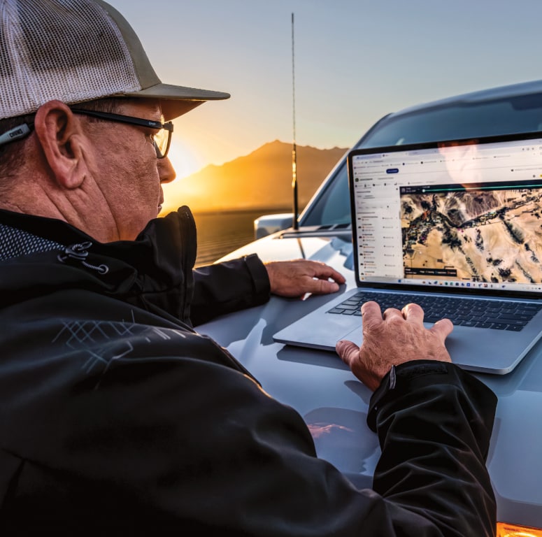 A researcher stands next to his truck