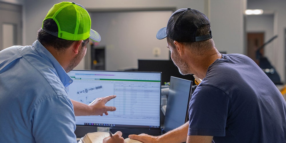 Two men looking at a computer