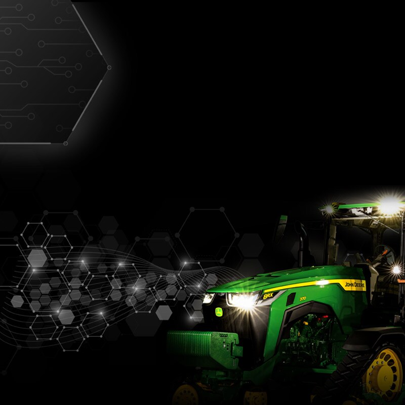 A John Deere tractor at night