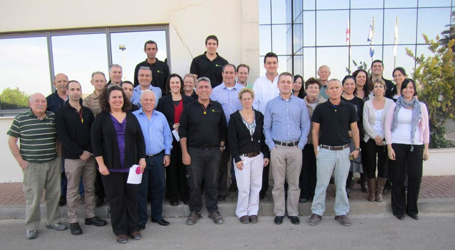 Jill Riedl (front row, purple shirt) stands next to her Israeli team in 2012. 