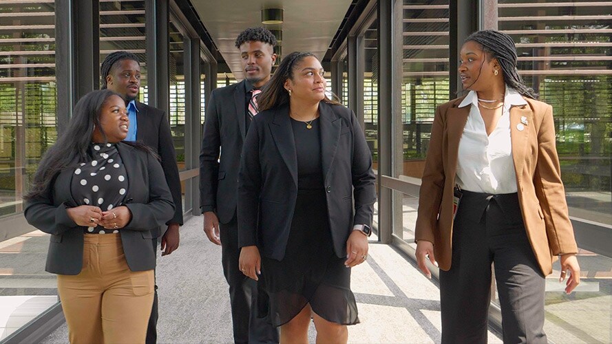 Five new LEAP Coalition interns walk and talk together at John Deere Headquarters