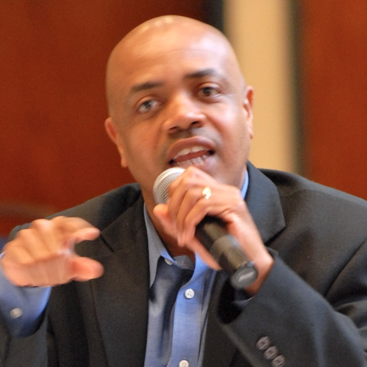 Cornelius Blanding speaks into a microphone