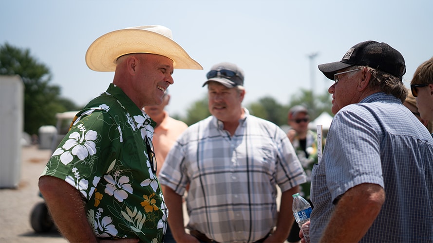 Representatives of Sinclair Tractor chat casually together