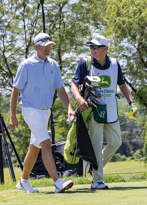 John C. May and Joel Oltman chatting between rounds