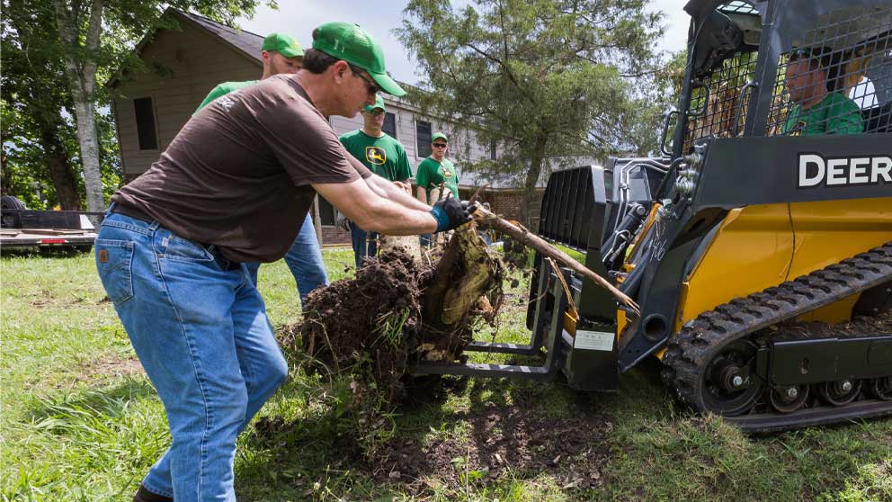 John Deere volunteers working with tree