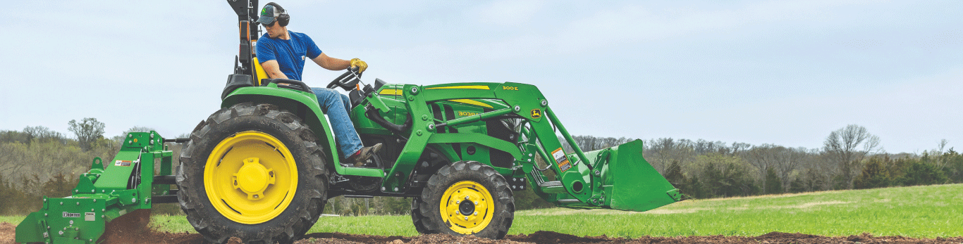 Man working on a properly ballasted tractor.