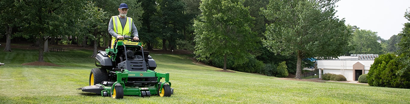 A man mowing with a QuikTrak mower