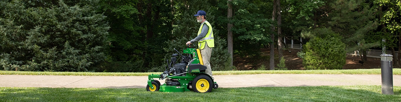 A man mowing with a QuikTrak mower