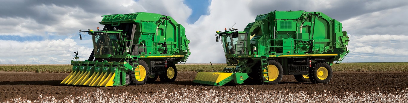 John Deere cotton picker and cotton stripper in the field.