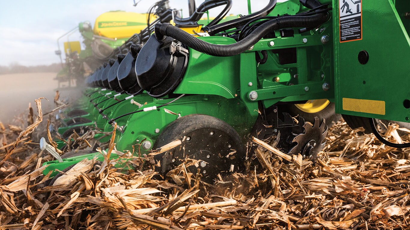 Planter in field of corn husks