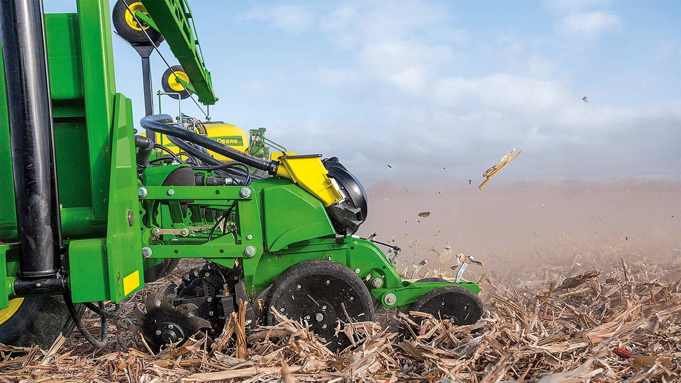 John Deere planter row unit at work in the field