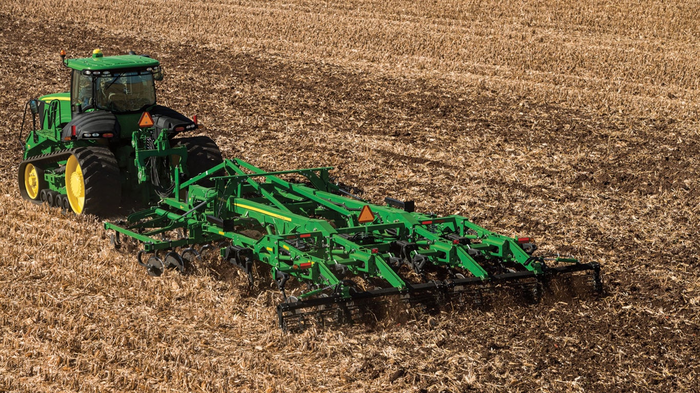 John Deere agriculture equipment tilling a field