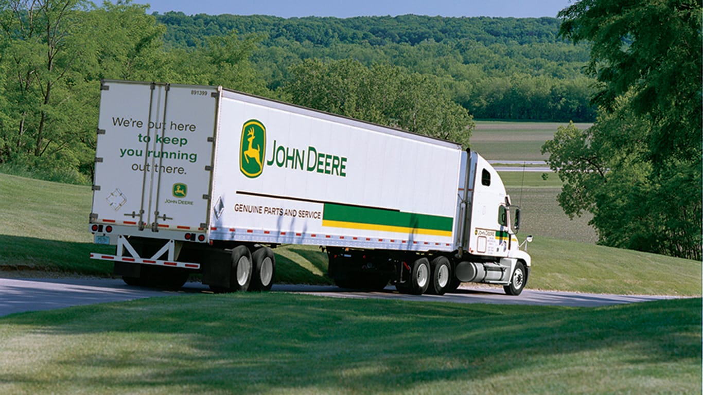 John Deere transport truck driving down road