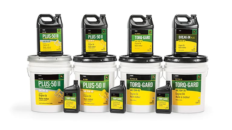 studio shot of various stacked containers of Deere oil