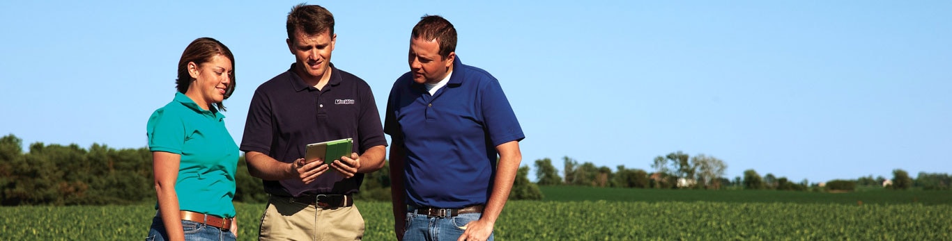     image of three individuals standing in field looking at a tablet with "StellarSupport" title listed