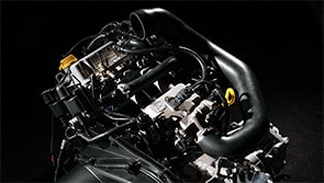 Close up of an engine on a black background.