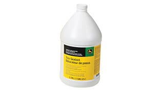 A one gallon container of John Deere Tire Sealant on a white background.