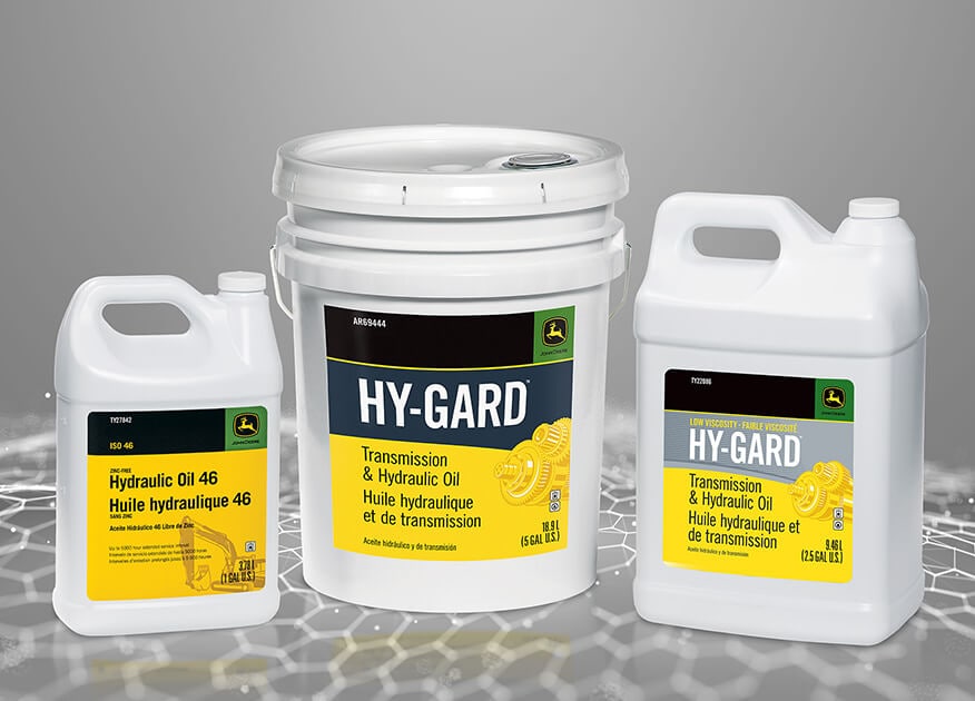Three containers of John&nbsp;Deere Hy-Gard Transmission & Hydraulic Oil in varying sizes on a gray background.