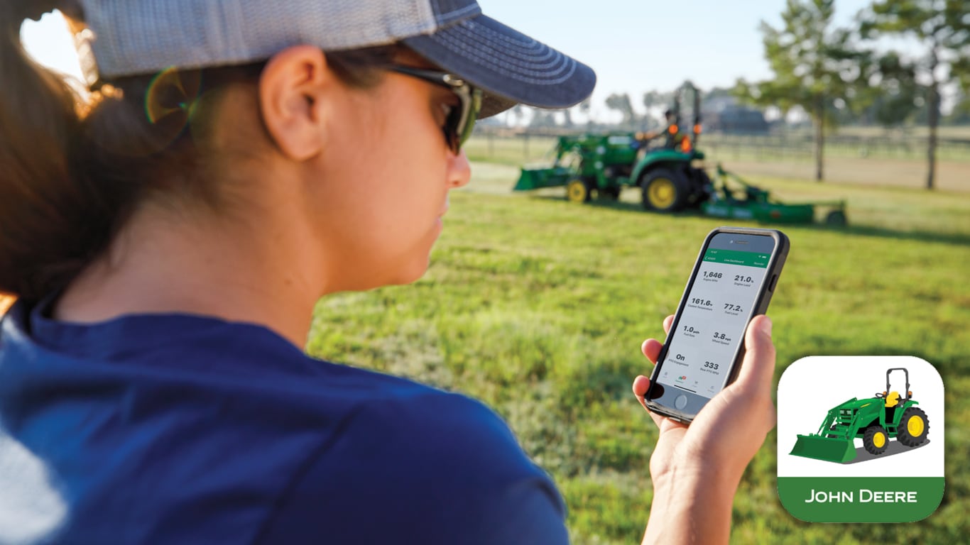 a woman viewing the TractorPlus&trade; App on her phone