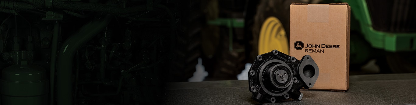 John Deere Parts on a table with a closeup of a tractor in the background.