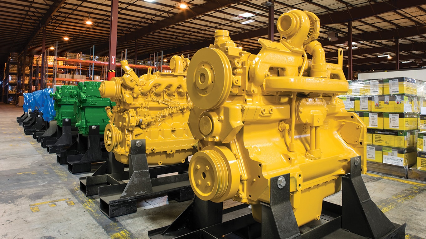 Yellow and green remanufactured engines in the John&nbsp;Deere Reman warehouse.