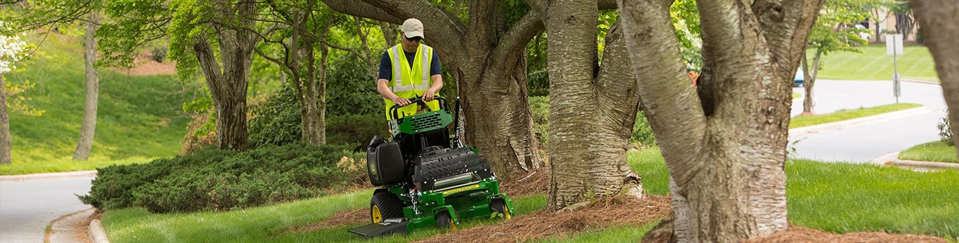 A man on a QuikTrak mower