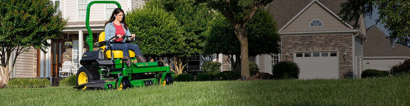 Woman driving a z735e mower in her yard