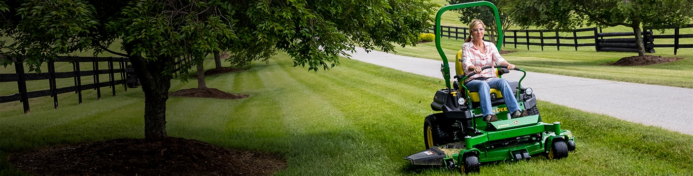 Woman driving a z749r along some trees