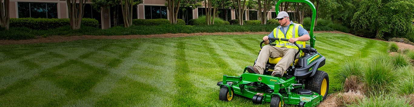 Man driving a z945m behind an office building