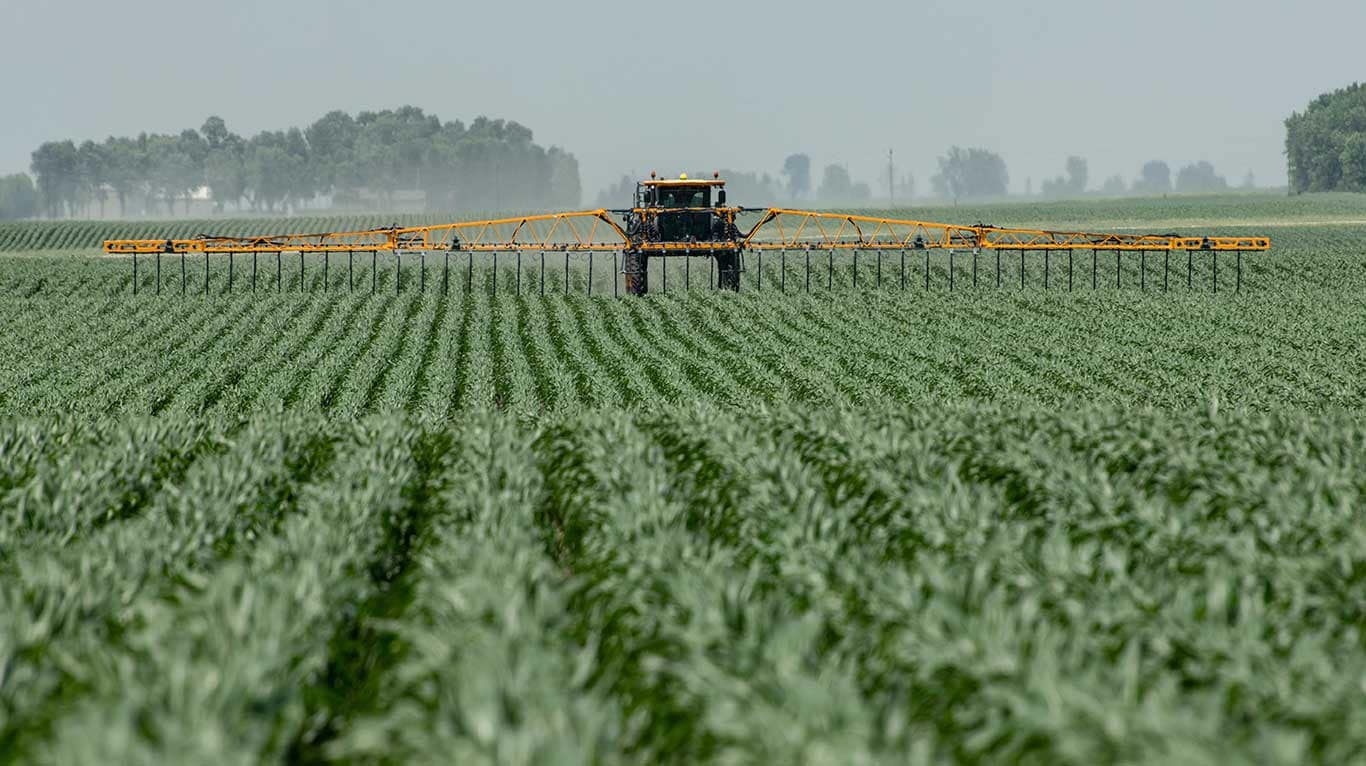 Hagie STS12 Sprayer applying nitrogen in a corn field with ExactDrop