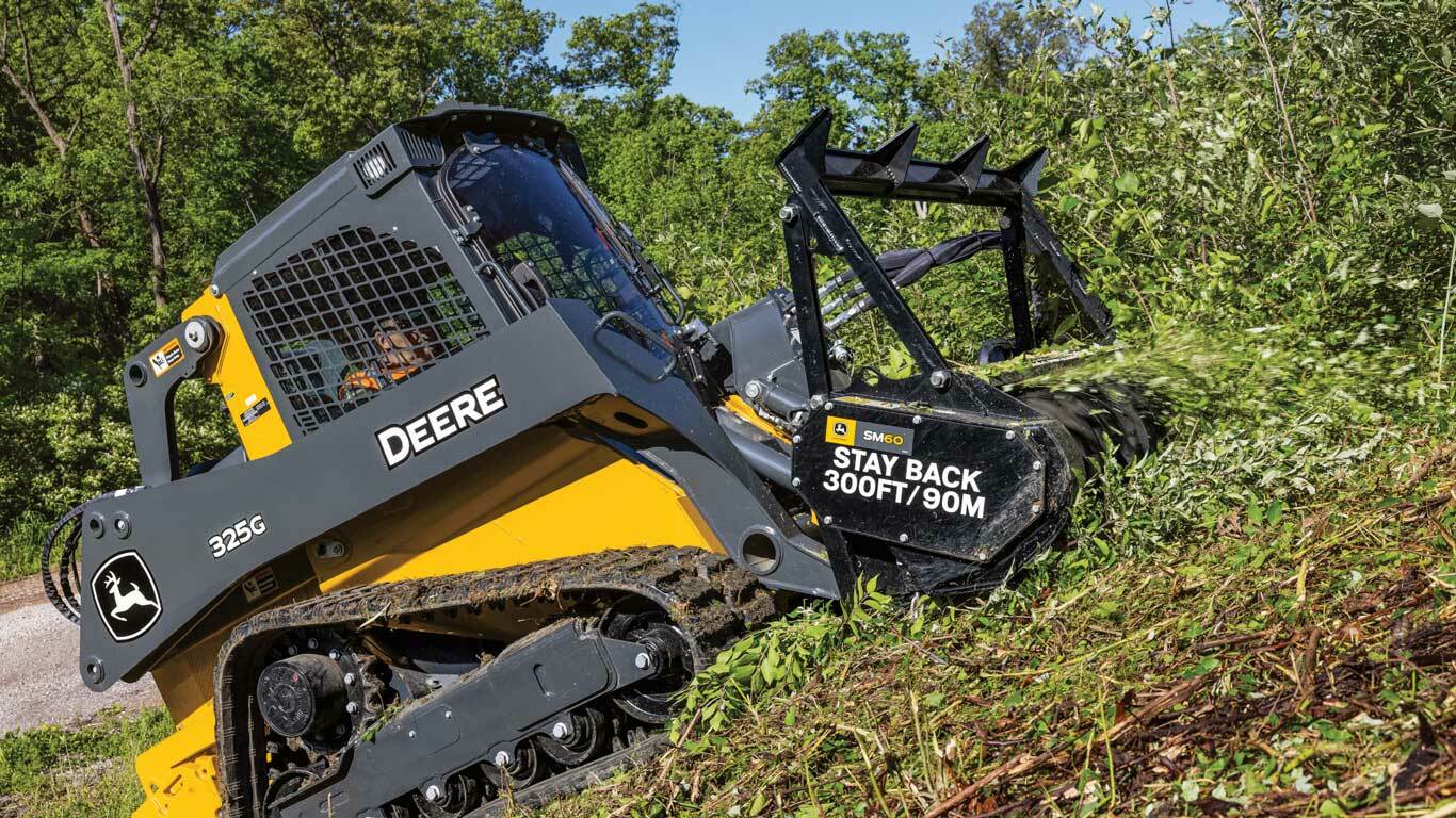 325G Skid Steer with tracks and SM60 Mulching Head working through brush