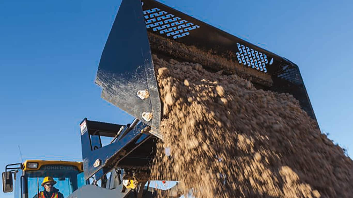 a rollout bucket dumping dirt