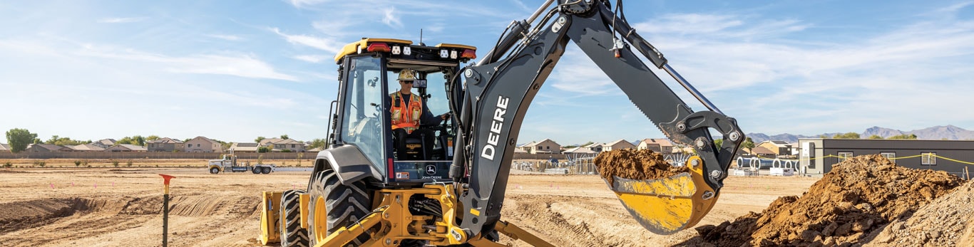 410 P-Tier backhoe digs a trench on a jobsite