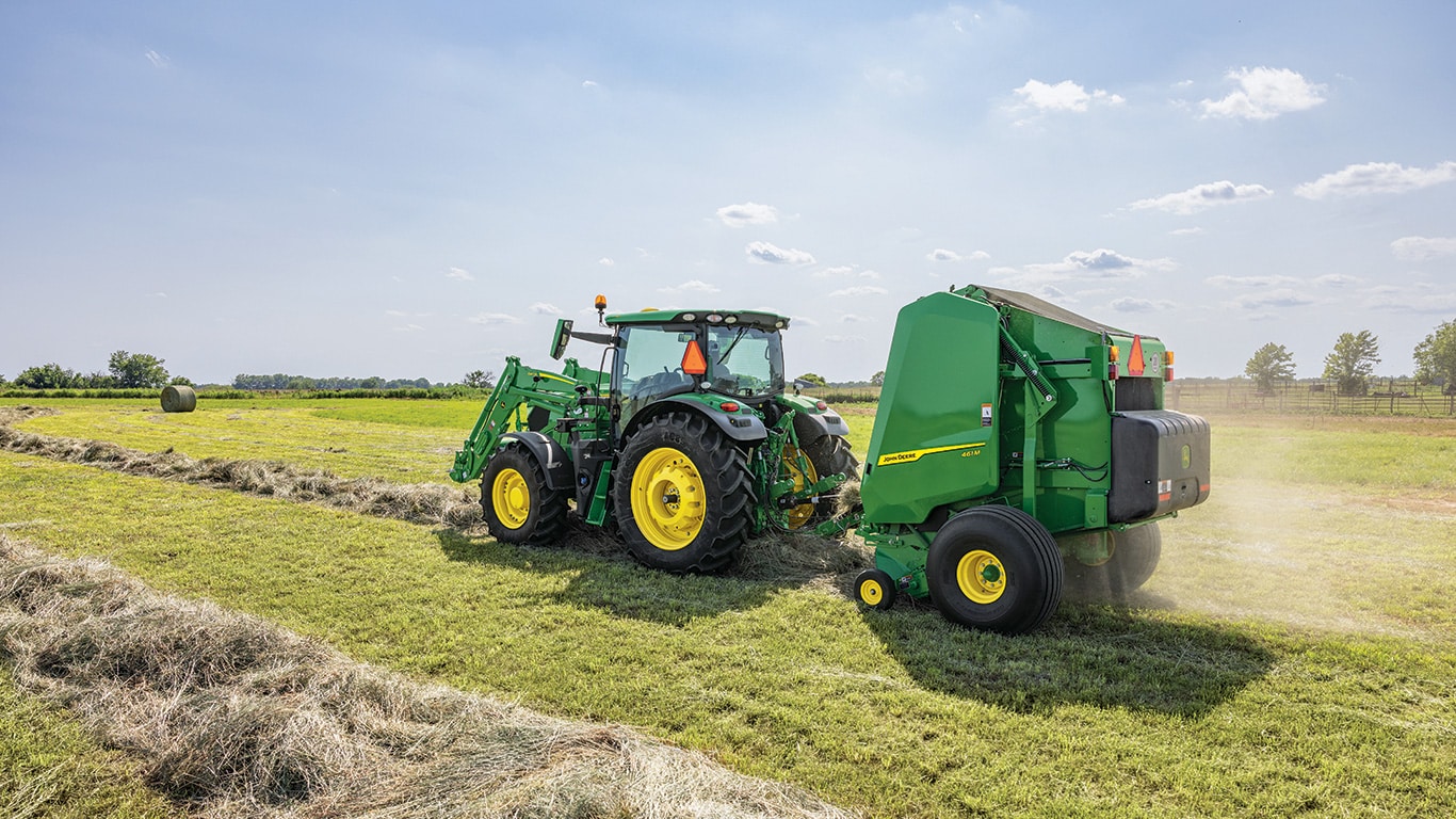 tractor pulling a baler in a field
