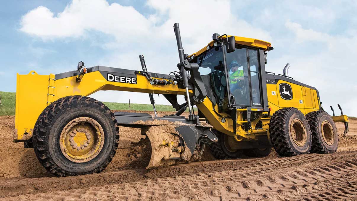 Motor grader grading dirt surface