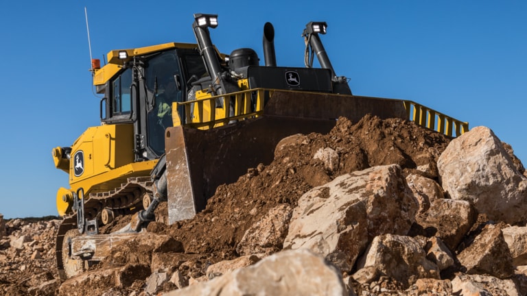 1050 P-Tier dozer moving rock on the job site.