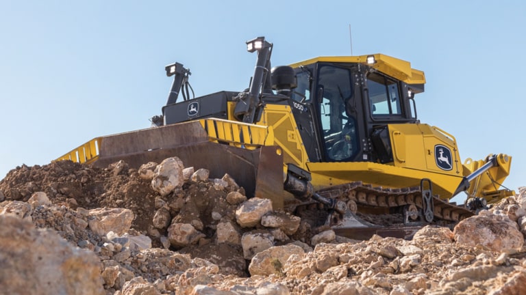 1050 P-Tier dozer moving rock on site.