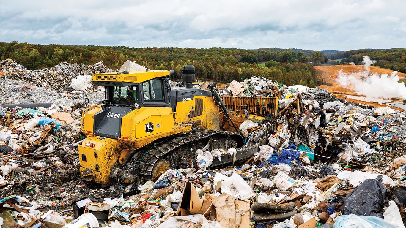 A 950K Dozer pushing garbage into piles at a landfill.