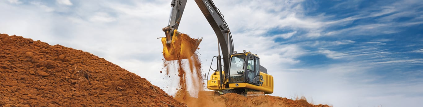 John Deere excavator working on job site moving dirt with bucket.