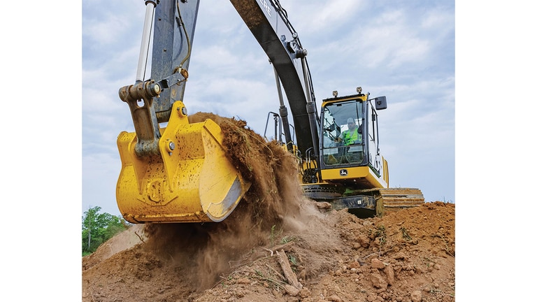 Un operador usa una Excavadora 210P-Tier para recoger tierra de la parte superior de una pila.