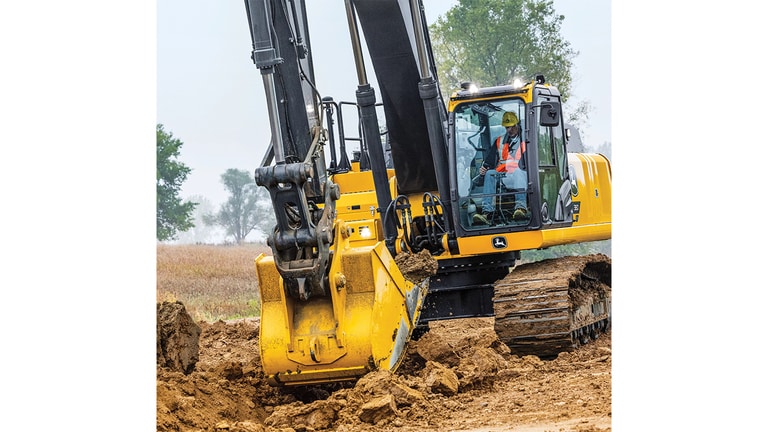 An operator using a 380P-Tier Excavator to move dirt.