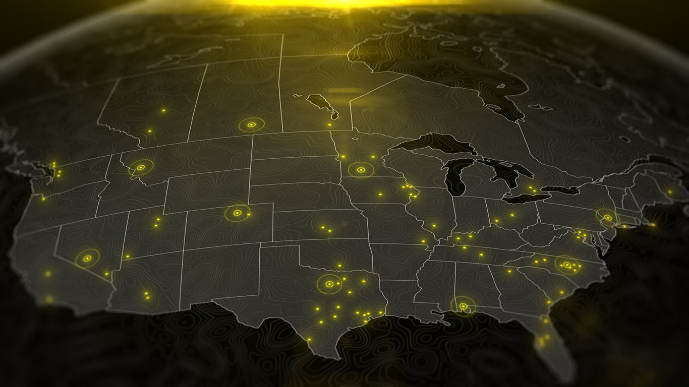 Map of North America highlighting various cities agraphic showing where excavator test pilots are located across US and Canadawith markers in black, orange, and gray, indicating specific dealer locations.