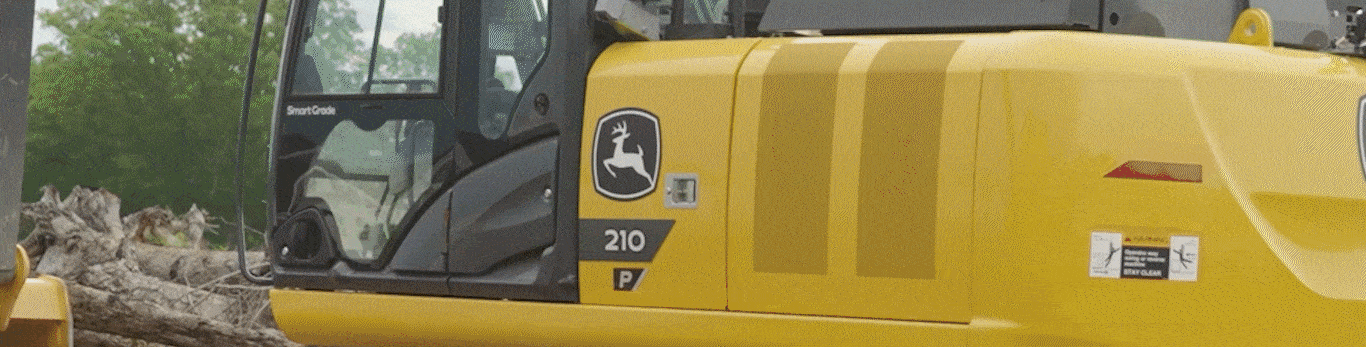 A 210 P-Tier Excavator scooping up dirt